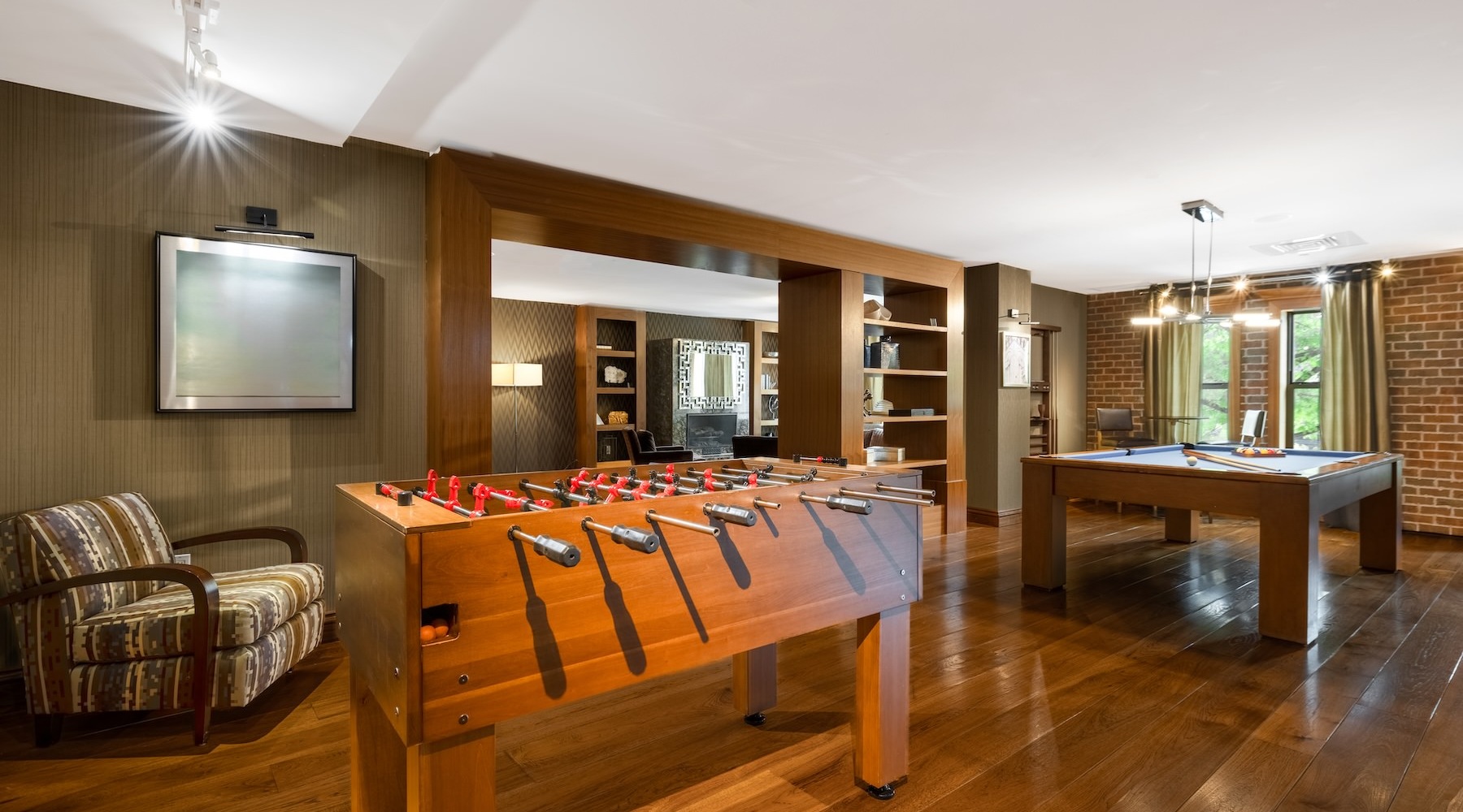 State-of-the-art amenities a clubroom with a foosball table and a pool table