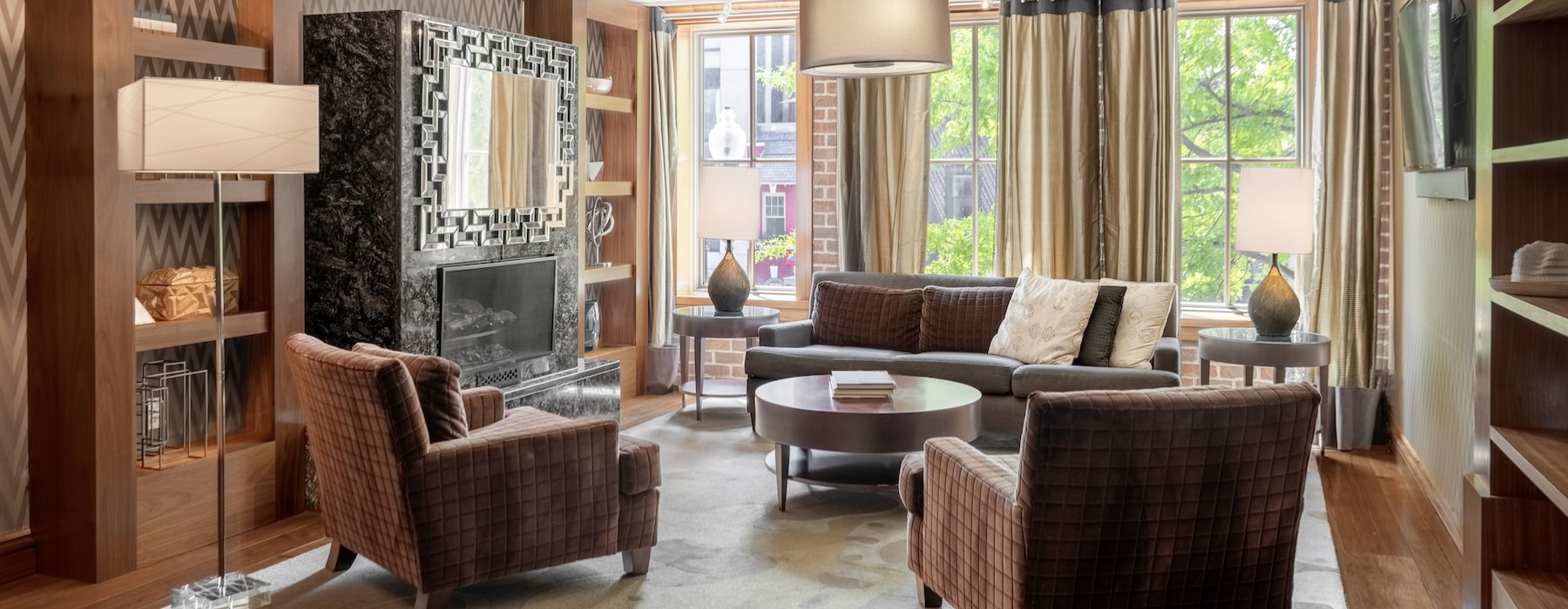 a clubroom with a couch, tables and chairs