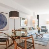 a living room with a couch and a dining table and chairs