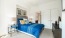 a bedroom with a bed and a desk