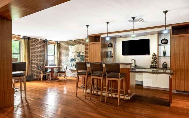 a clubroom kitchen with a tv and chairs