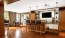 a clubroom kitchen with a tv and chairs
