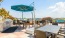 a rooftop grill area with tables and chairs